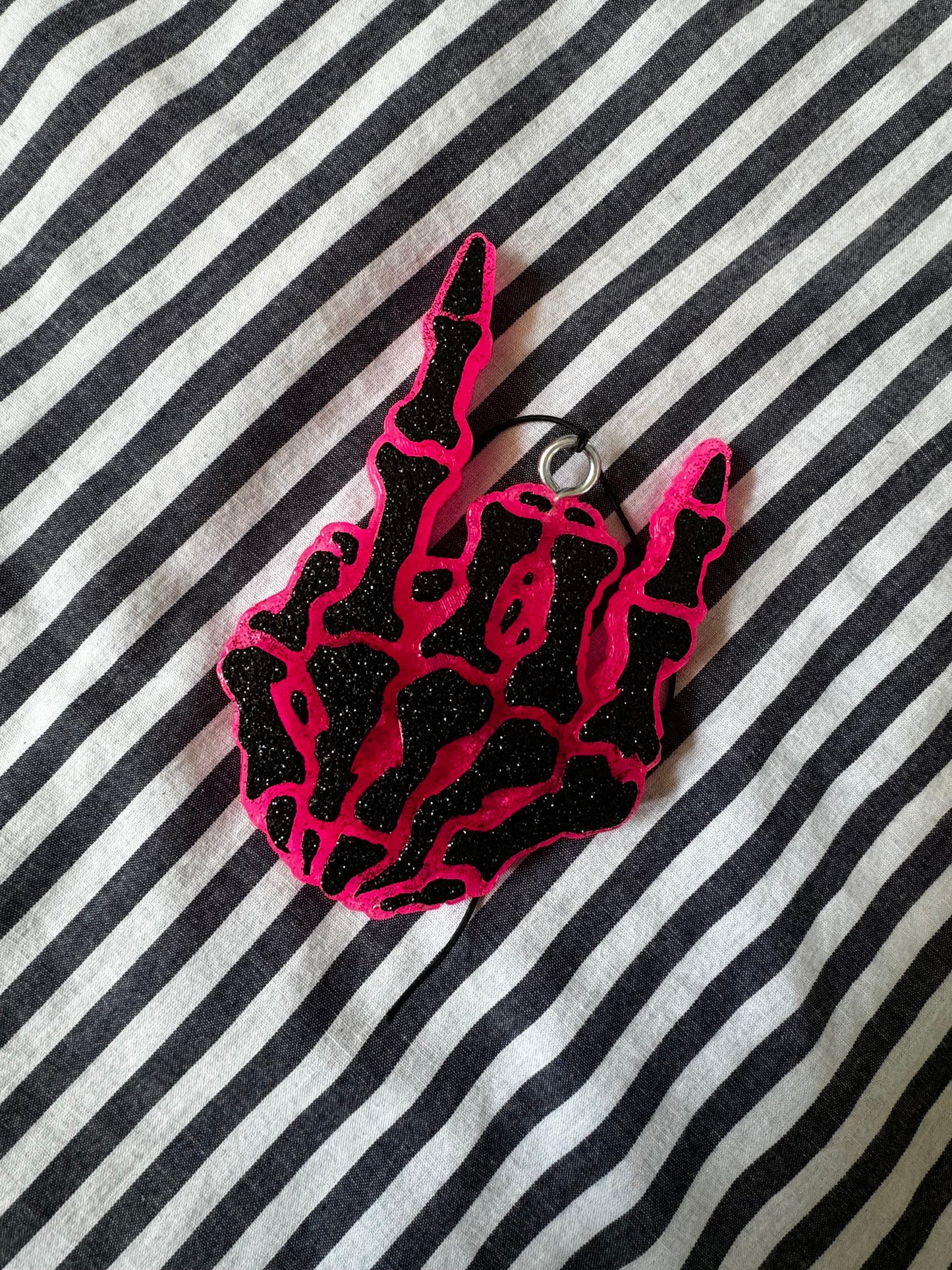 The Branded Roan - Black & Pink Skull Hand